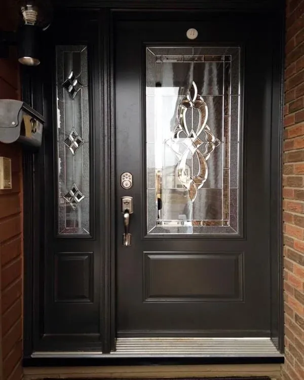 Matte black entry door with decorative leaded glass and sidelight on a Newmarket home