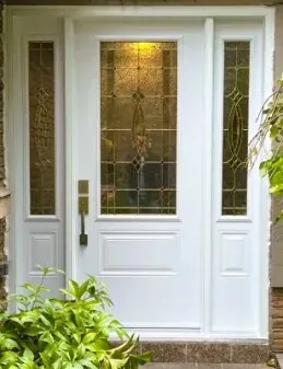 White entry door with decorative leaded glass sidelights on a Newmarket home
